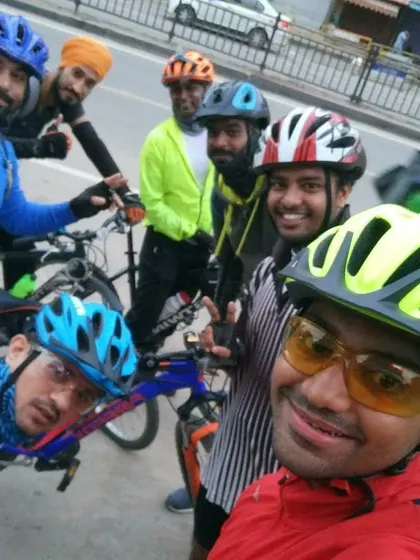 Another great selfie capturing the diverse faces of our cycling group during a quick stop.