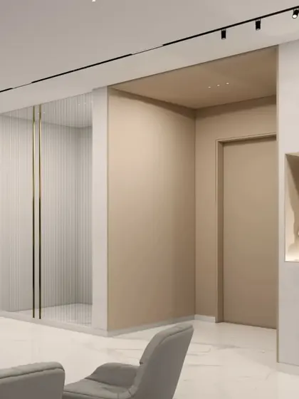 An entryway concept for the Gulecha Residence, where art and architecture merge. A niche for a statement sculpture and a gallery wall for photographs personalize the space, while a fluted glass partition offers a hint of the rooms beyond.