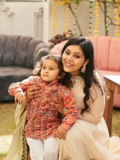 A mother and her child share a quiet moment together during a family event.