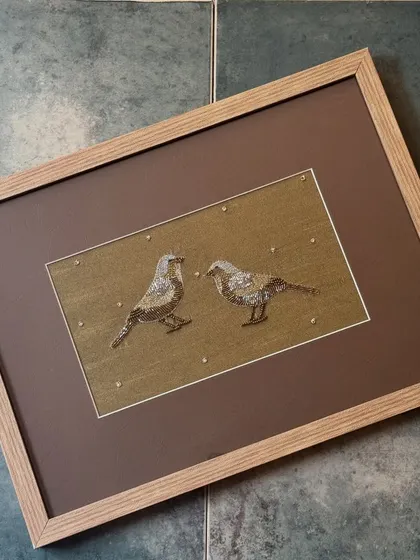 This framed Zardosi embroidery of two birds, created for us by the Monami Foundation, is a beautiful example of textile art. It blends seamlessly into the colourful world of whimsical animals and birds at our stores.