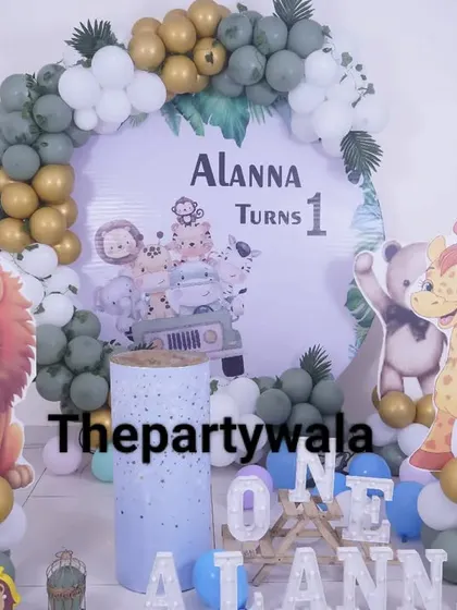 A sweet jungle theme for a first birthday, with cute, cartoonish animal cutouts. The green and gold balloon arch is accented with white balloons for a softer look.