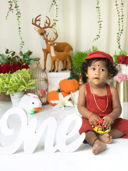 A different take on the festive theme with a bold red outfit. This little one is ready to celebrate his first birthday surrounded by holiday cheer.
