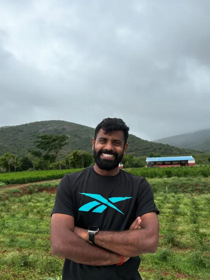 A smile carved by winds, a soul shaped by trails. A portrait shot against a beautiful hilly backdrop.