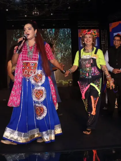 Sharing a lighthearted moment on stage with a uniquely dressed guest. I love celebrating the creativity and spirit of the audience, making them feel recognized and appreciated.