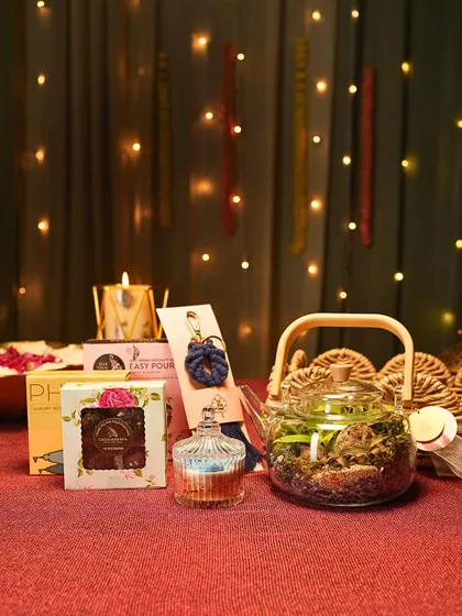 Here you can see the individual elements of my festive hamper coming together. It includes a teapot terrarium, a scented candle, handmade chocolates, and other small treasures to delight the senses.