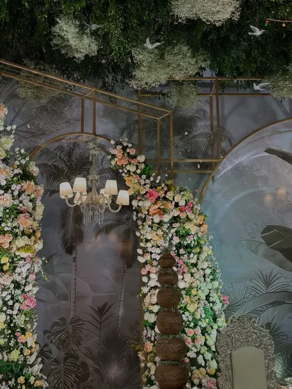 Another angle of the enchanted garden stage, showcasing the interplay of light, florals, and a custom-designed backdrop to create a truly magical setting.