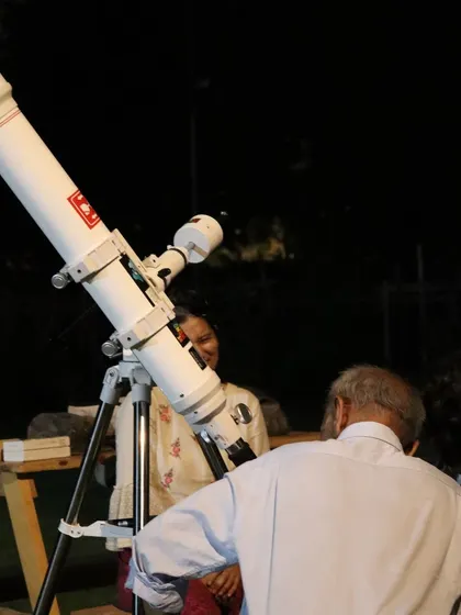 Guests gather around the telescope for our night sky safari.
