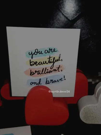 A close-up of our red heart photo holder displaying a positive affirmation card. It's a small detail that can bring a smile to your face every day.