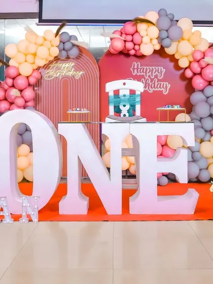 A playful 'Mickey Mouse' themed birthday party, with bright colors, character cutouts, and a fun balloon arch, creating a joyful atmosphere for little ones.