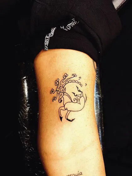 A whimsical, illustrative-style deer tattoo. This design has a storybook quality, showing our versatility in different artistic styles.