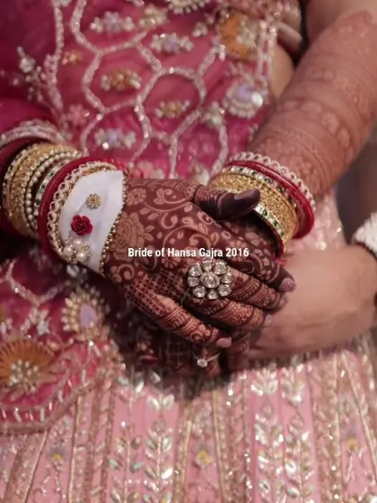 A close-up of the bride's hands, showcasing her intricate mehendi, beautiful rings, and traditional bangles. Every detail comes together to create a perfect bridal look.