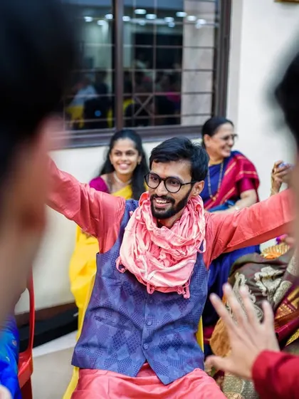 The groom, Deven, getting surrounded by his friends after their epic sangeet performance. A moment of pure fun and friendship.