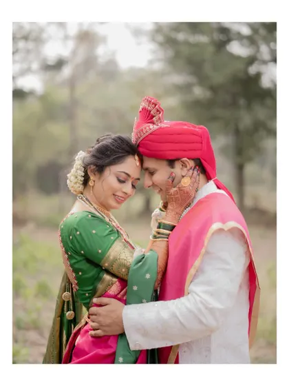 A close-up portrait of the bride and groom in a tender embrace during their outdoor wedding photoshoot.