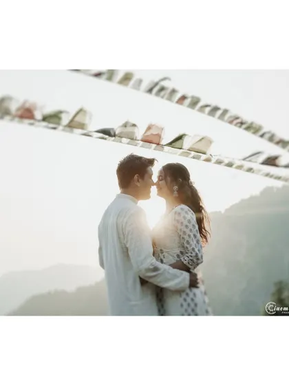 A beautiful silhouette created by the setting sun in the mountains. The prayer flags add a touch of local culture and color to this intimate and romantic pre-wedding photograph.