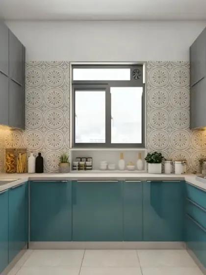 A compact U-shaped kitchen that uses a two-tone color scheme of teal and grey to create a stylish look. The patterned backsplash and under-cabinet lighting enhance the design and functionality.