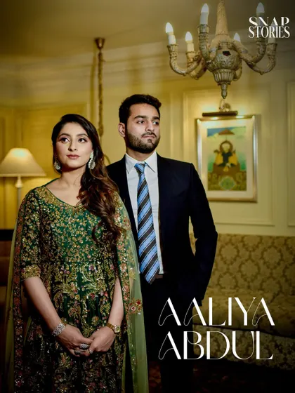 A beautifully lit close-up portrait of the couple in a warm, ambient indoor setting, capturing a mood of quiet sophistication and romance.