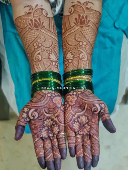 The beautiful result of a bridal henna application. The deep, rich stain highlights the intricate lotus and peacock designs.
