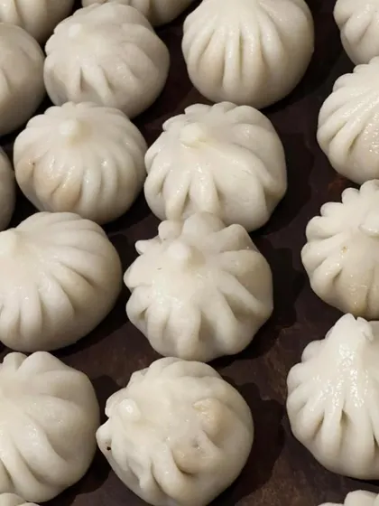 Perfectly pleated Ukadiche Modak, a traditional steamed sweet dumpling offered during the Ganesh Chaturthi festival.