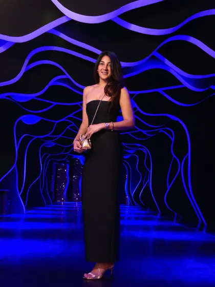 Attending a luxury launch event in a classic black strapless gown. Sometimes, the simplest silhouette makes the biggest impact.
