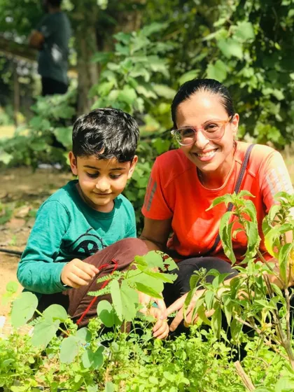 A mother and son take a moment to inspect the plants up close. I encourage this curiosity as it helps children build a deeper appreciation for nature.