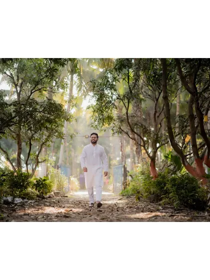 The groom on his way to the Haldi ceremony, captured in a beautiful, natural setting.