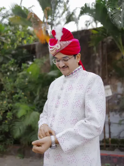 A candid shot of the groom adjusting his watch, a classic pose that adds a touch of style and anticipation.