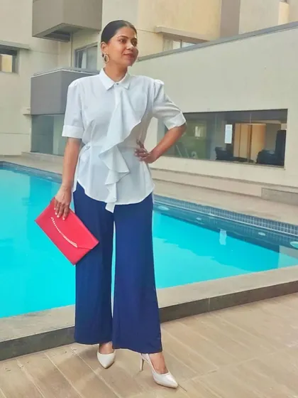 My goal is to help you build a wardrobe that makes you feel confident and put-together, no matter the occasion. Here, I'm showing a powerful yet comfortable look that combines a structured top with wide-leg trousers and a pop of color.