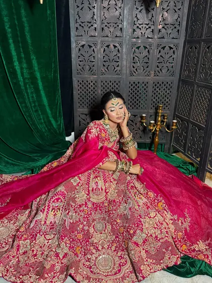 This full-length shot shows how the makeup and styling come together to create a cohesive and stunning bridal vision. The makeup is designed to look just as good from a distance as it does up close.