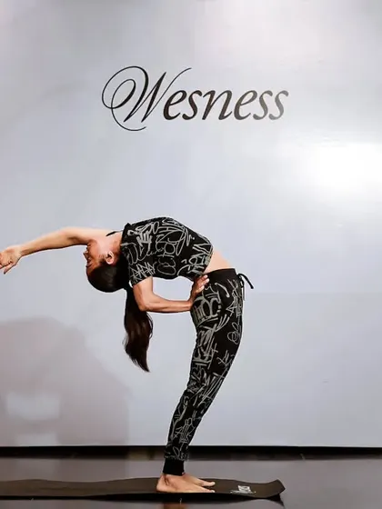 Yoga gives time, it doesn't take it. Here I am demonstrating a deep backbend at a brand event, combining my love for the practice with stylish and functional athleisure.