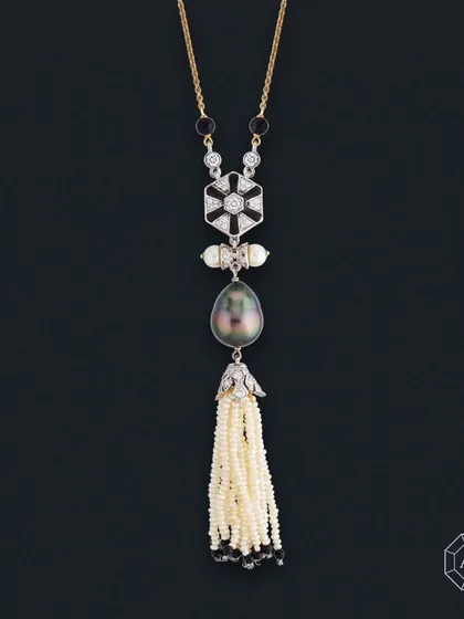 Crafted in a stunning lariat style, this necklace features 18Kt gold, round diamonds, South Sea pearls, a Grey Tahitian Pearl, and Onyx.