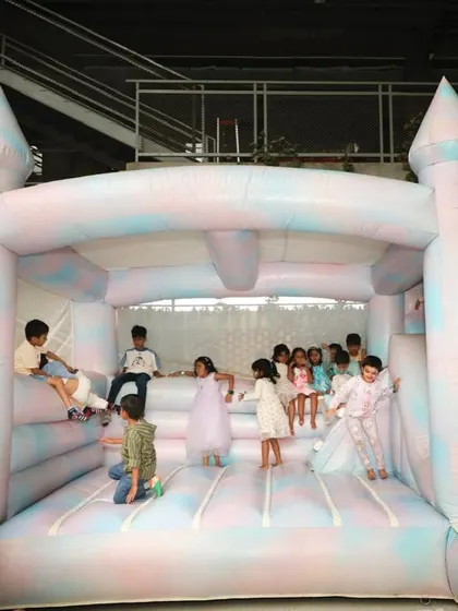 Pure joy on the bouncy castle. We included this all-white inflatable castle, decorated with pastel tie-dye colors, to match the elegant aesthetic while providing endless fun.