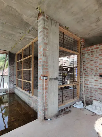The wooden frames for large windows are set in place, beginning to define the relationship between the interior and the view.