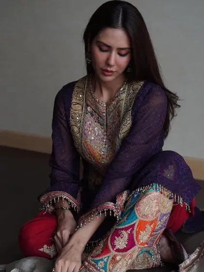 A quiet, graceful moment with Sonam Bajwa. The deep purple and red tones of this outfit are rich and royal, perfect for an evening celebration.