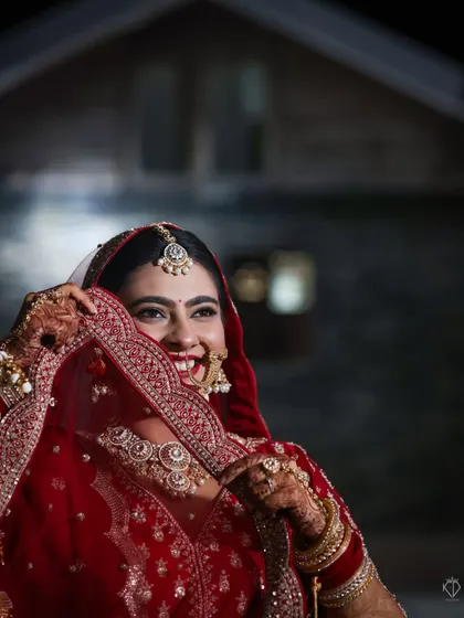 A candid moment of laughter, with the bride looking away from the camera. This natural shot, taken at night, feels intimate and full of life.