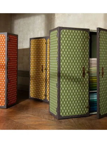 These unique storage trunks are reimagined with a Tuareg-inspired jacquard fabric. This demonstrates my approach to creative upholstery, applying luxurious textiles to unexpected pieces to create bespoke furniture.