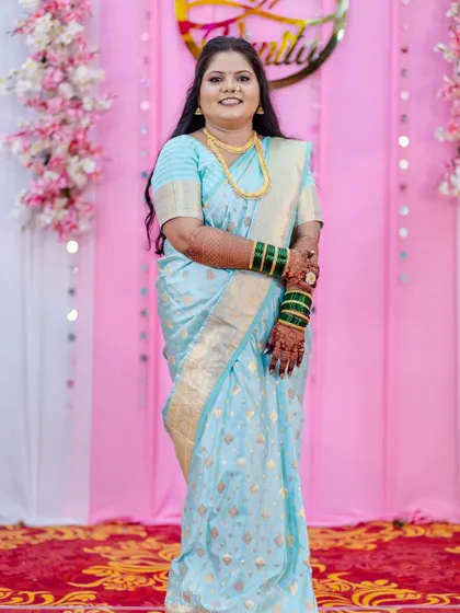 A complete head-to-toe engagement look. This photo showcases not just the flawless makeup but also the elegant hairstyling and professional saree draping I provide to ensure my brides look polished and feel confident from every angle.