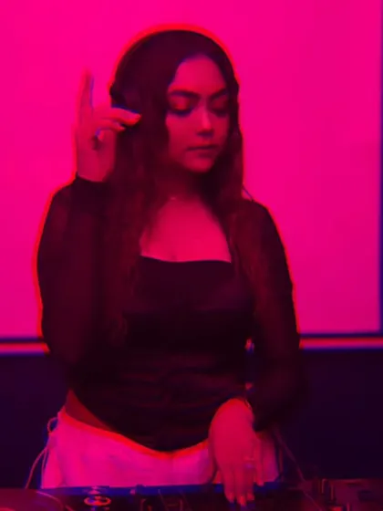 A stylized, pink-tinted photo of me listening intently, embodying the belief that anything is possible.