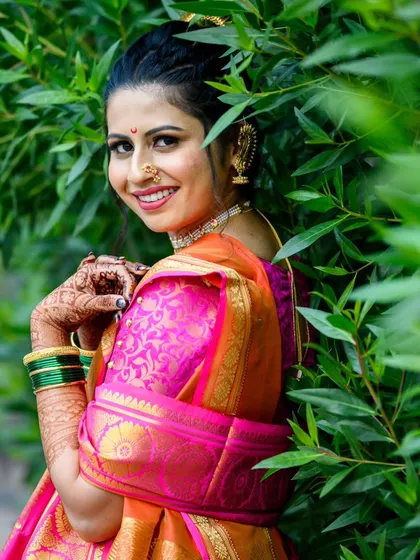 A classic bridal portrait. Shamika's beautiful smile and elegant pose against the lush green background make for a timeless photo.