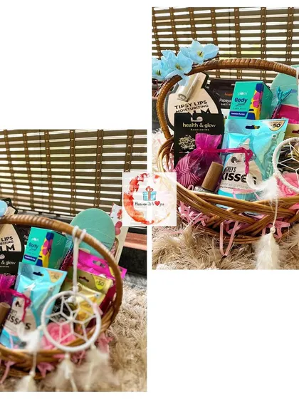 A vibrant and fun birthday basket for her. This gift includes a dreamcatcher, various skincare and beauty products, and is decorated with blue flowers for a bohemian feel.