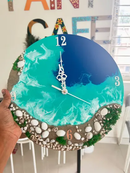A beach-themed resin clock featuring real sand, shells, and moss, bringing a piece of the serene coastline into your home or office.