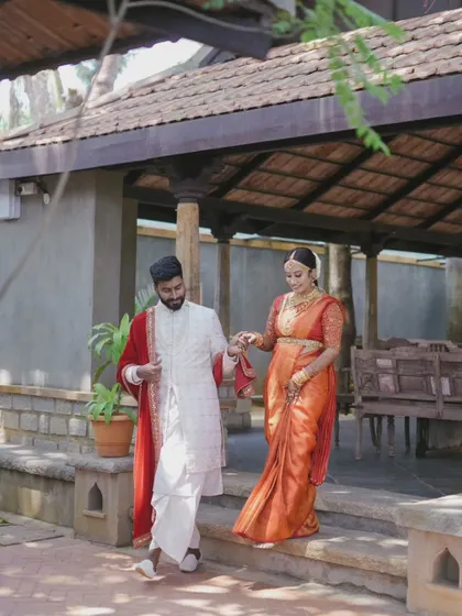 A duplicate of the couple walking hand-in-hand through the venue.