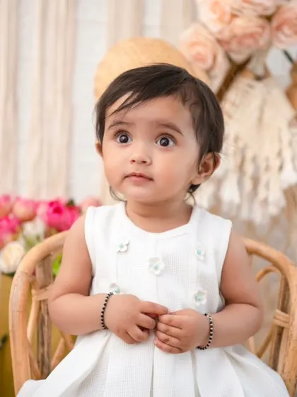 A curious gaze. This close-up shot in the boho chair highlights the baby's beautiful eyes and innocent expression.