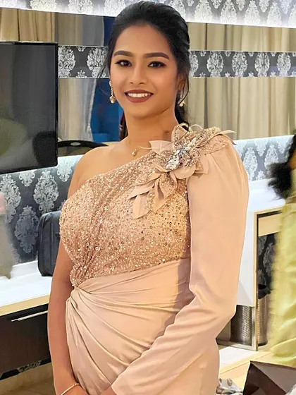 A smiling portrait, capturing her confidence and the sparkle of her glamorous outfit.