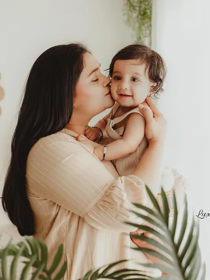 A mother's loving kiss on her baby's cheek. We use a soft, cinematic editing style to enhance the warmth and emotion of the moment.