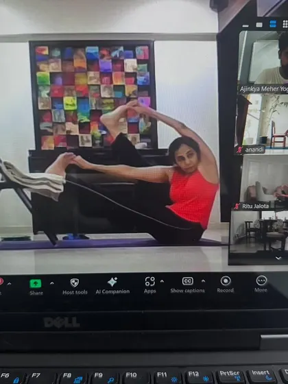 This student is using a chair to work on her flexibility in our online hip-opening class. Props are great tools, even when you are practicing from home.