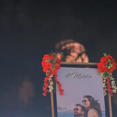 A personalized welcome board featuring the couple's photo and their wedding hashtag, 'Maisha'. This is a great way to welcome guests and make them feel part of the celebration.
