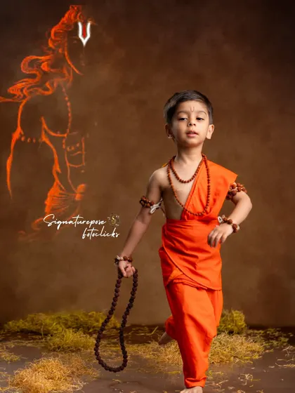This creative portrait features a young boy as Rama with a glowing illustration of the deity behind him, symbolizing divine guidance. This is an example of my artistic post-production work that adds a layer of storytelling to the photograph.
