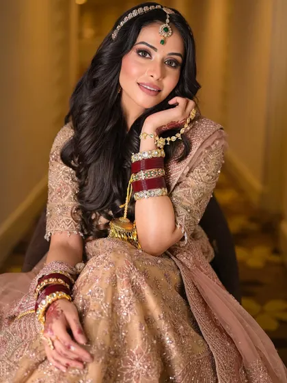 A playful and happy moment. The makeup looks just as beautiful when she smiles, proving that regal looks can also be fun and modern.