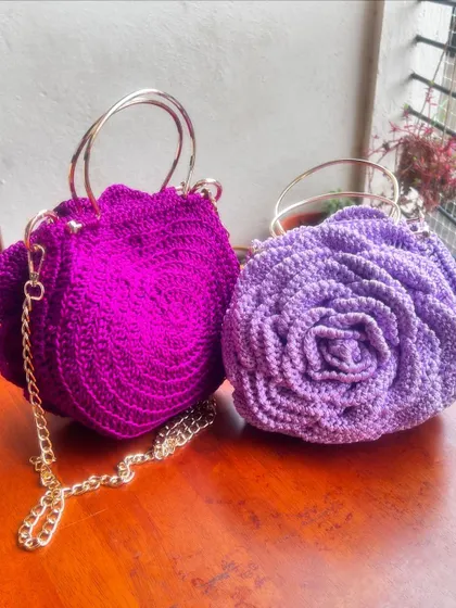 A pair of purple beauties. On the left is a vibrant magenta and on the right, a soft lavender Rose Bag, both complete with golden hardware.