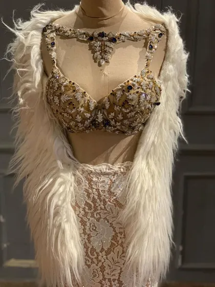A closer look at the intricate beadwork and embellishment on the bustier of our ivory lace lehenga.